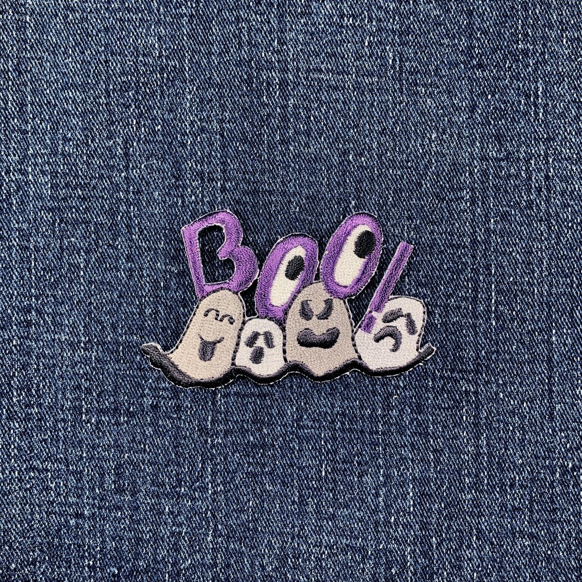 Embroidered patch with ghosts and 'BOO!' text on denim fabric