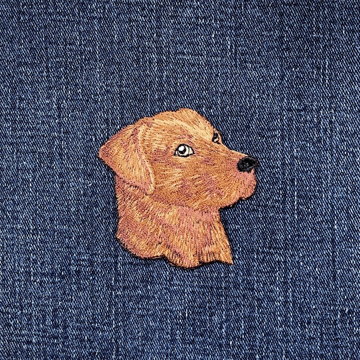 Embroidered dog patch on denim fabric