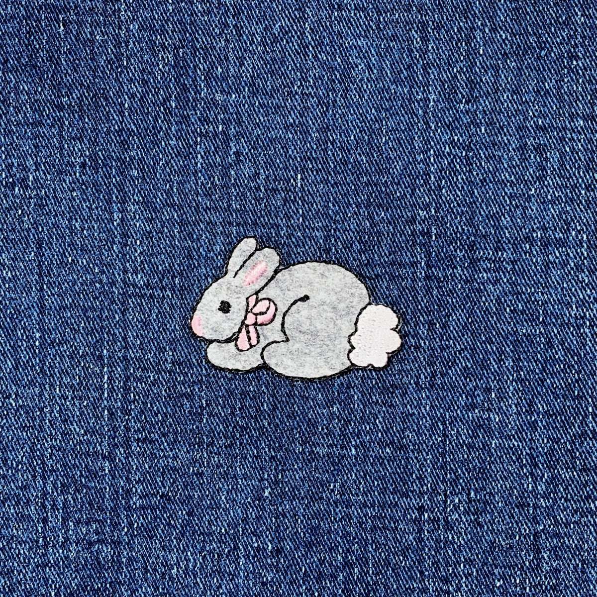 Embroidered bunny patch on denim fabric