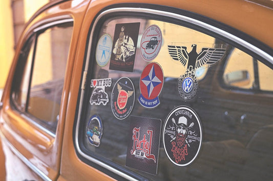 closeup photo of assorted-design decals on vehicle window