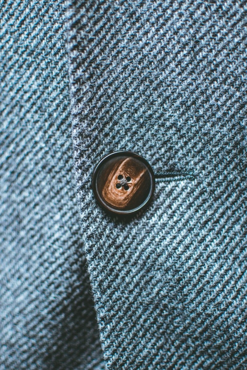 silver round coin on blue textile
