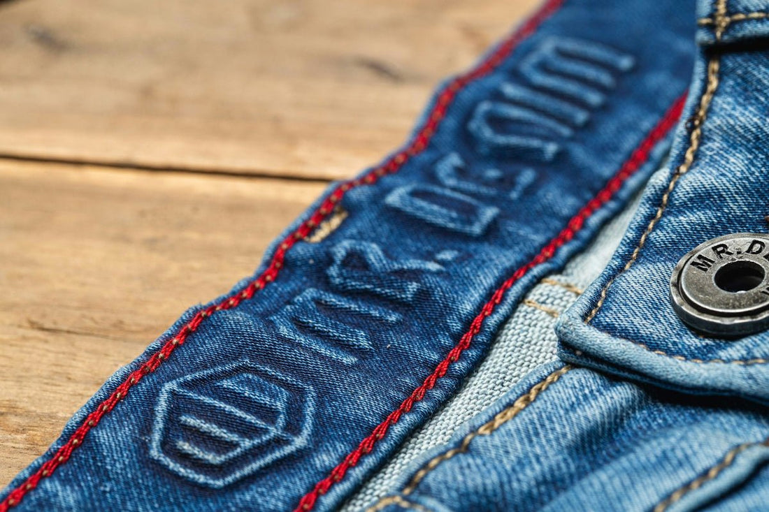 blue denim jeans on brown wooden table