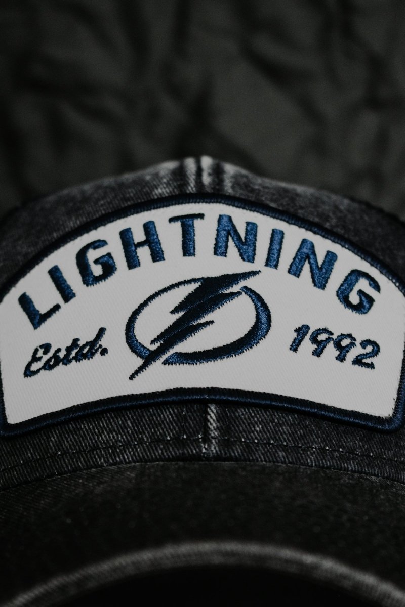 a black hat with a lightning patch on it