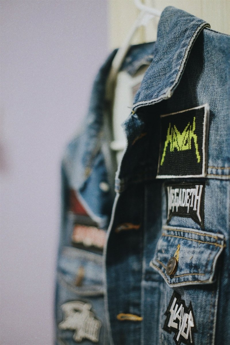 a denim jacket with patches on the back of it