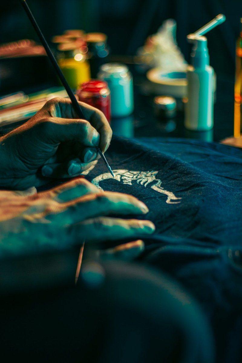 a person with their hands on a t - shirt