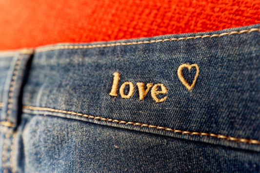 a pair of jeans with the word love written on them
