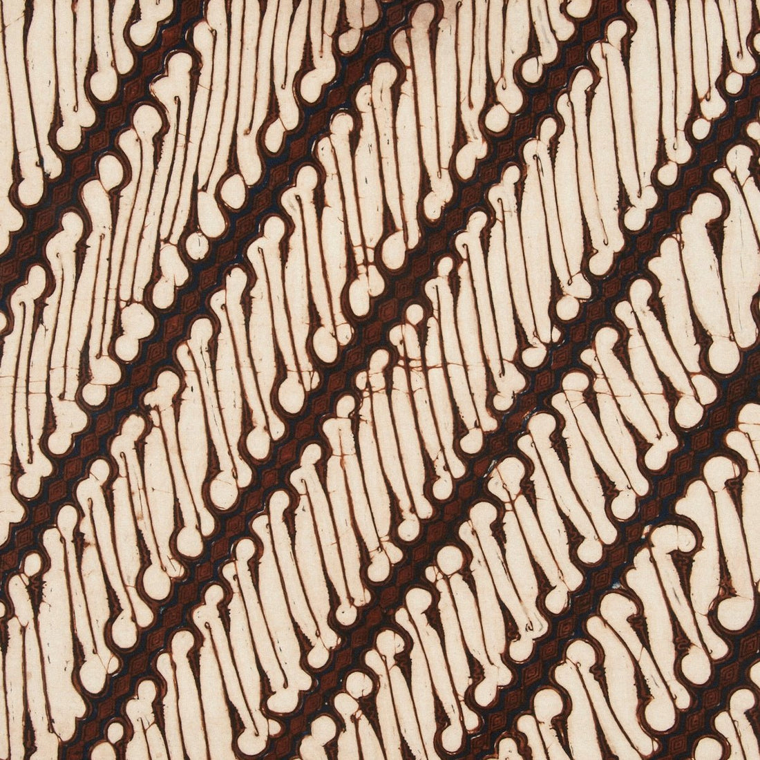 Diagonal pattern of brown lines on cream fabric