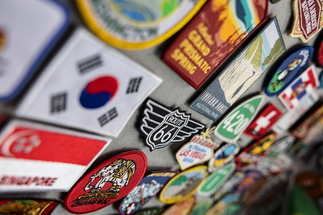 Colorful travel patches and magnets featuring flags and destinations.