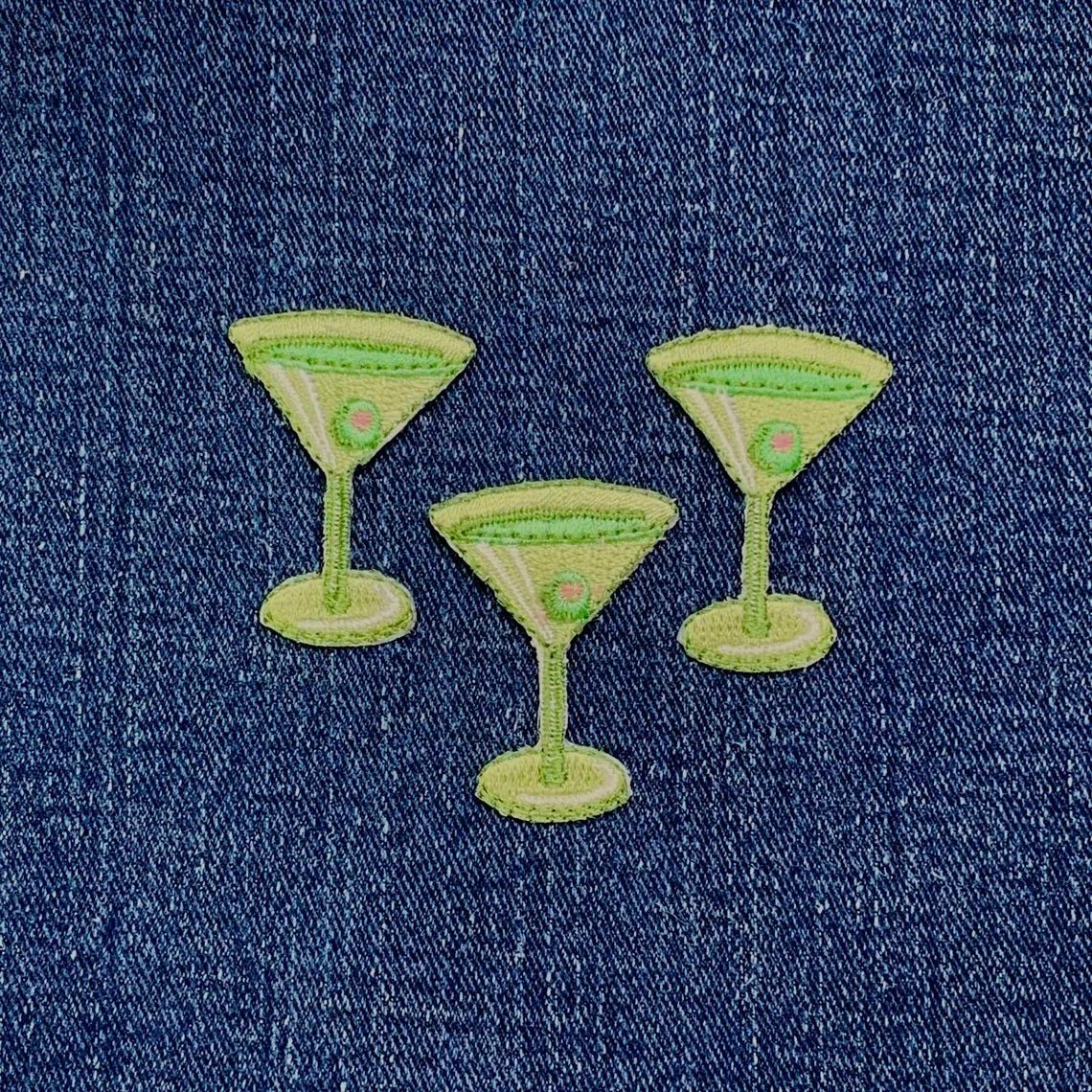 Three green cocktail glasses embroidered on denim fabric