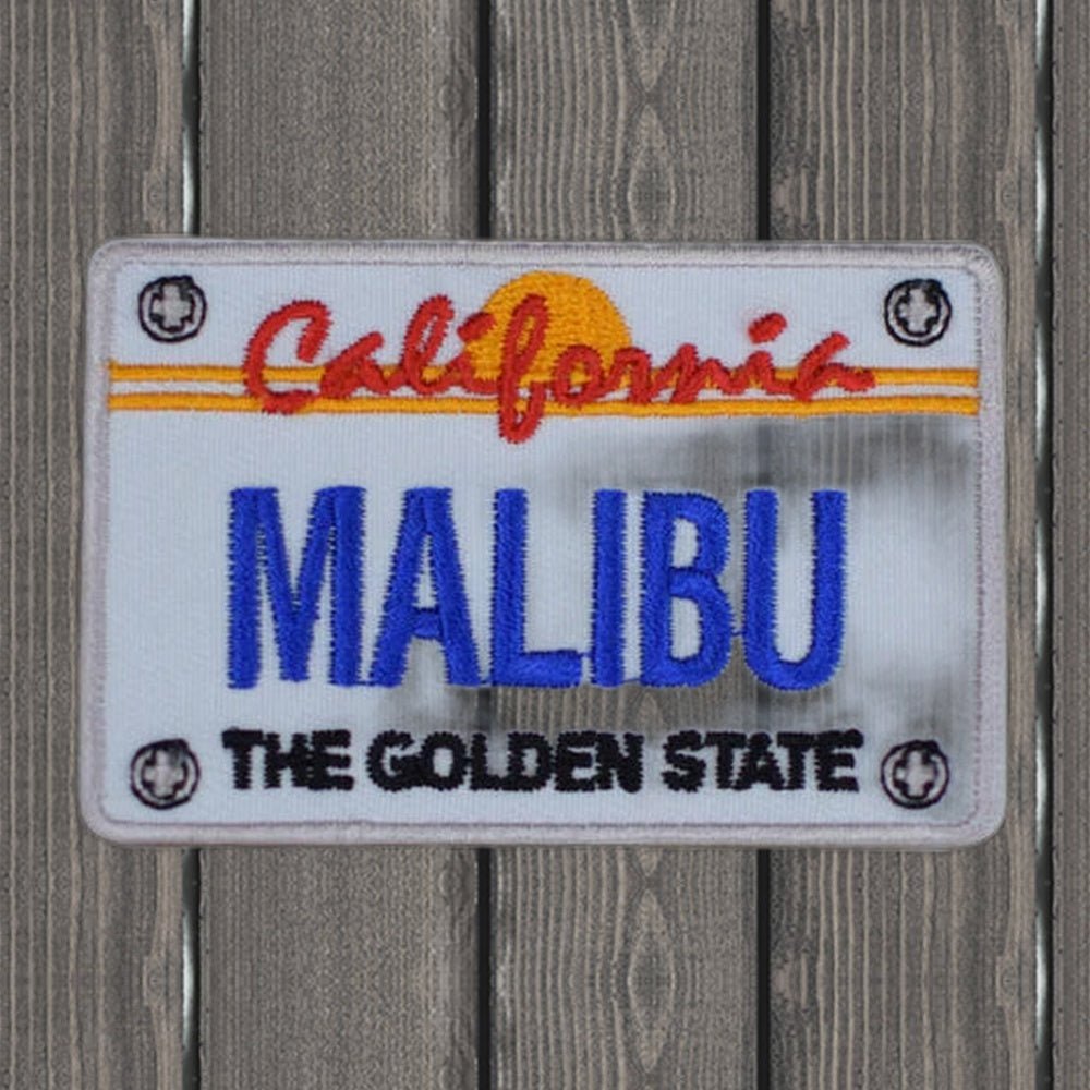 Malibu Patch - California License Plate Badge (2.75") - wood background
