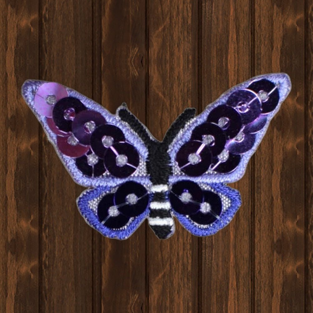 Purple Sequin Butterfly Applique Patch - 1-3/8" Iron-On Bug Badge - wood background