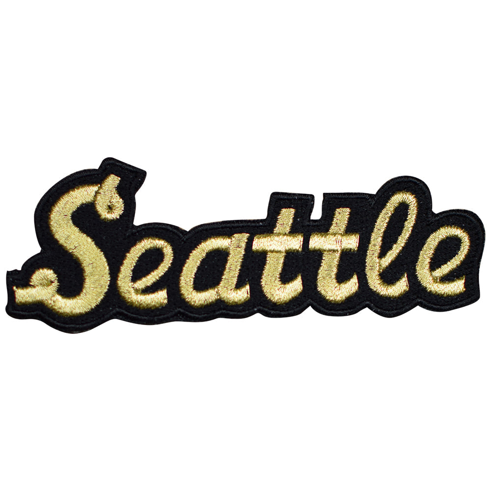 A metallic gold and black embroidered patch with the word 'Seattle' written in a stylized font.