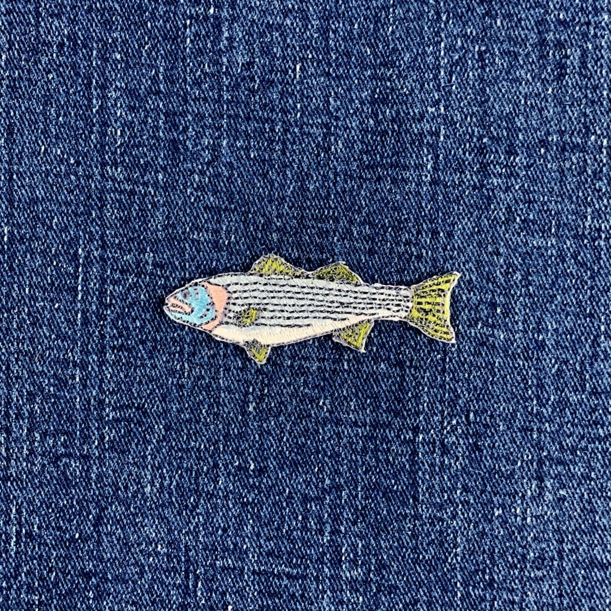 striped bass fish patch on a denim background