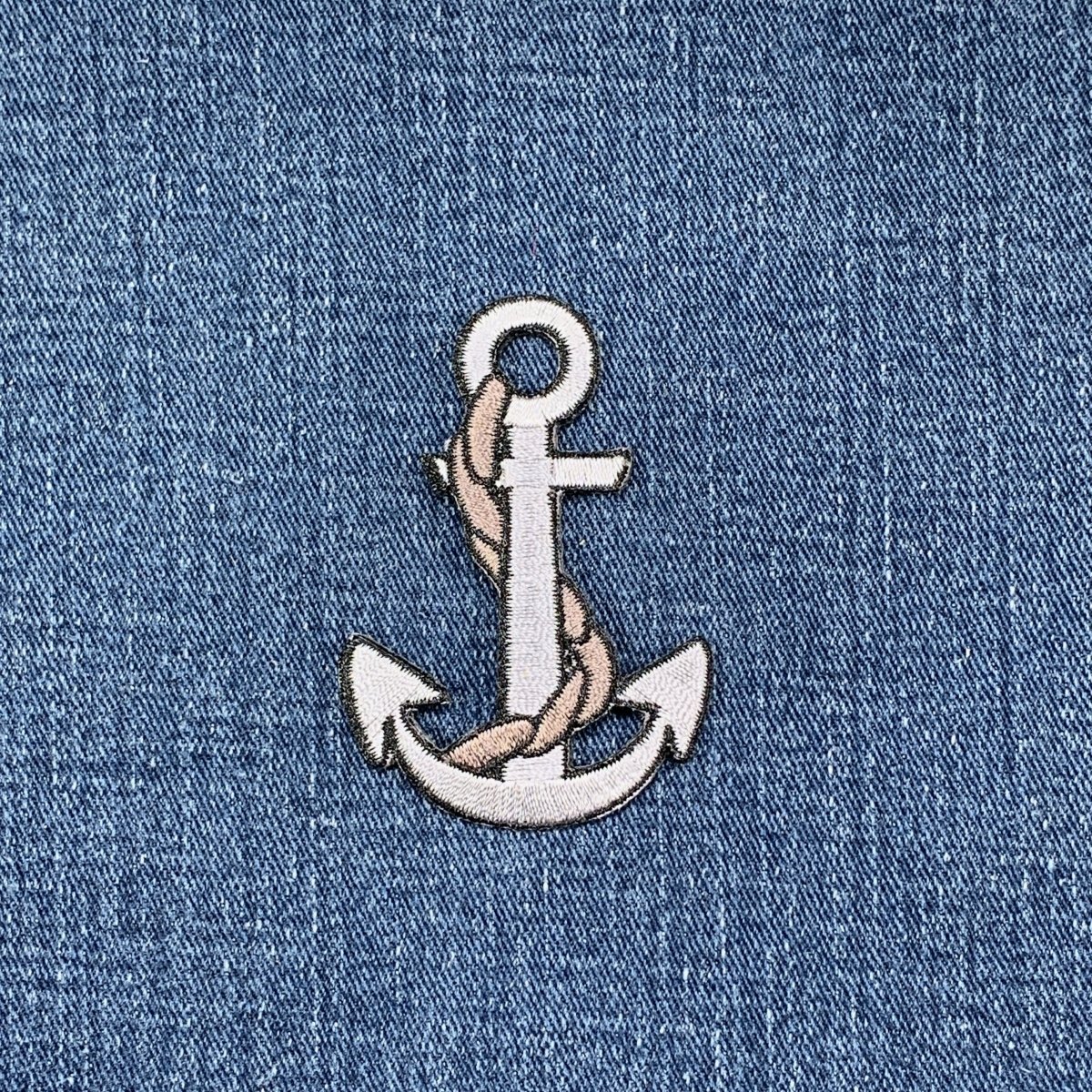 Embroidered anchor patch on denim fabric