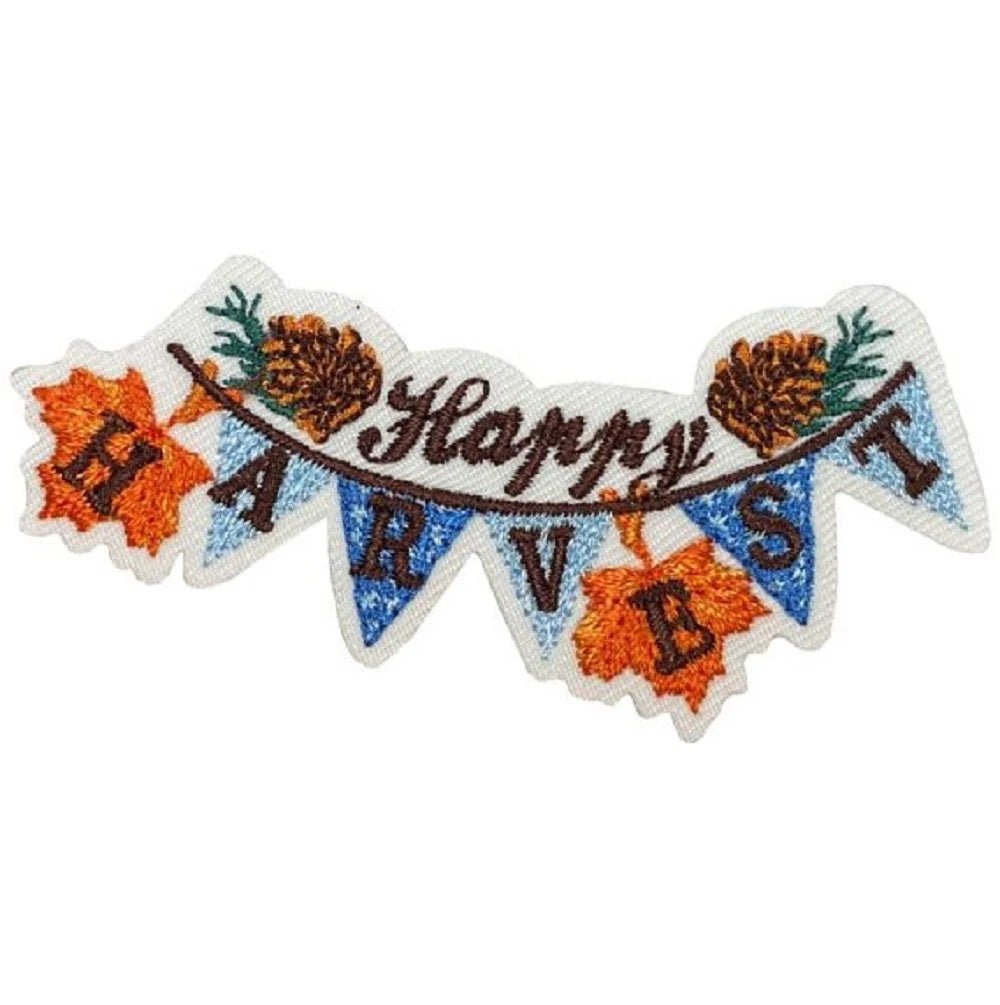 An embroidered appliqué patch shaped like a banner, featuring the text 'Happy Harvest.' 