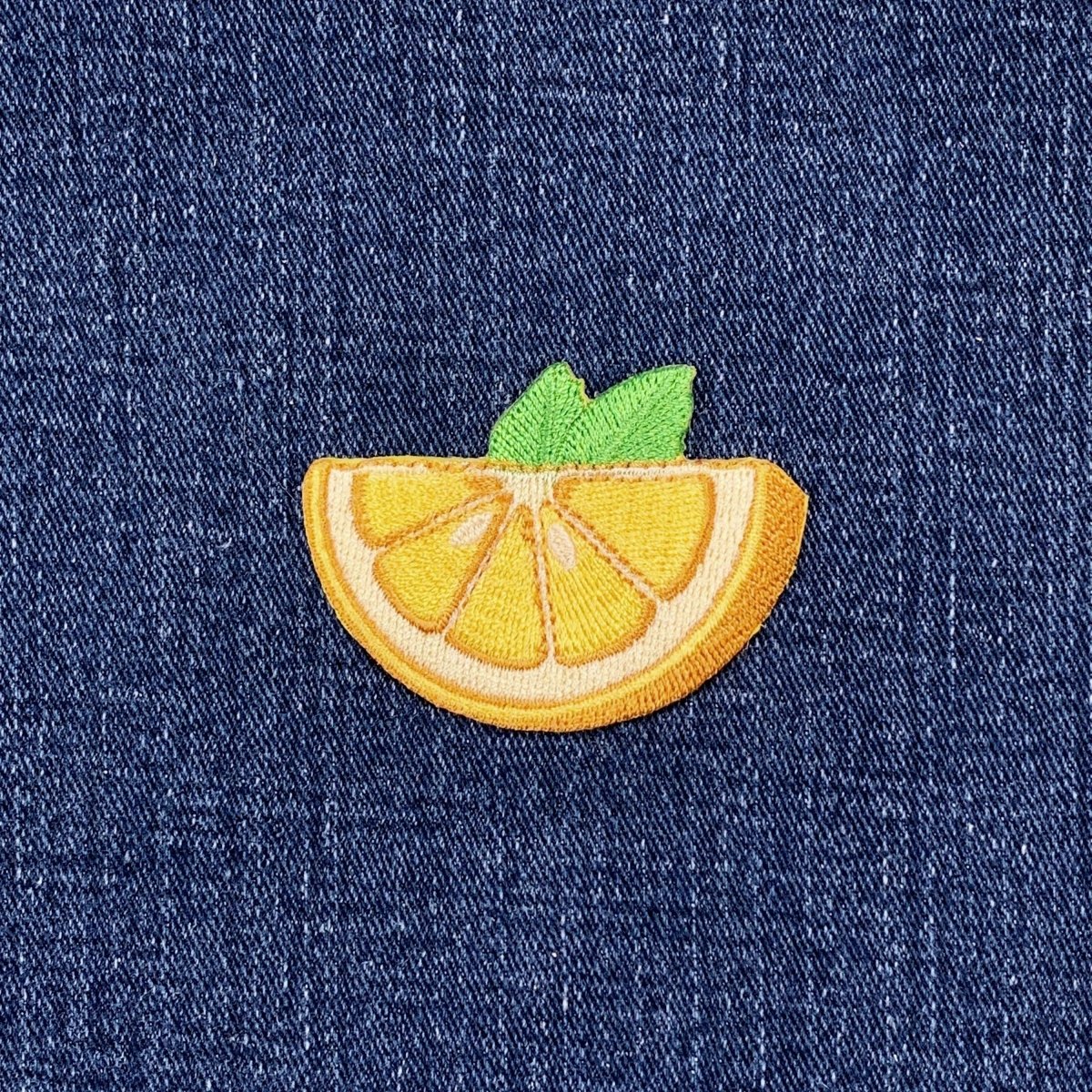 Embroidered lemon patch on denim fabric