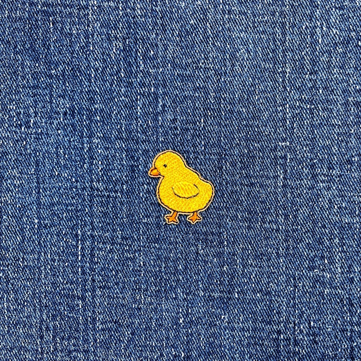 Yellow chick patch on blue denim fabric