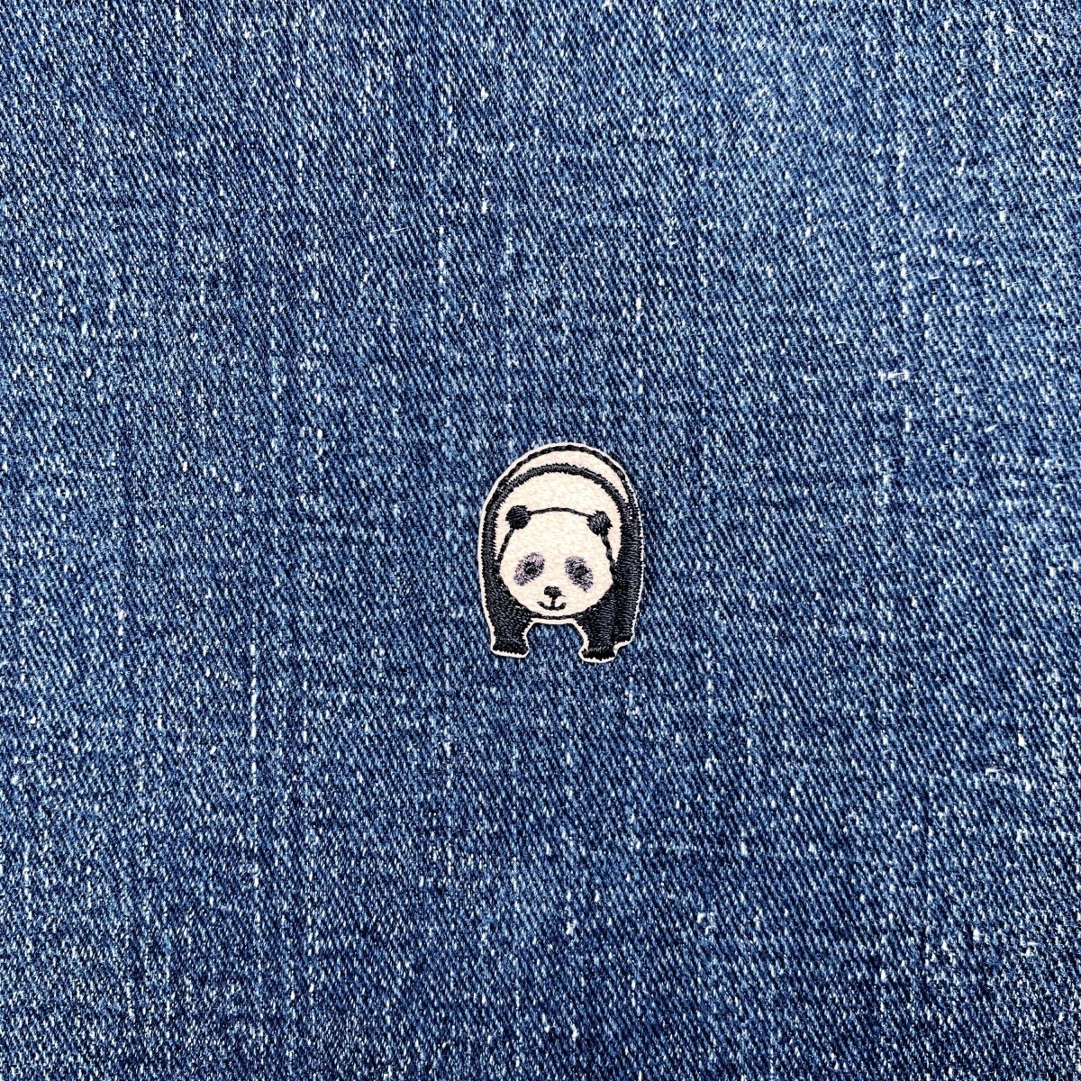 Panda-shaped patch on a denim background