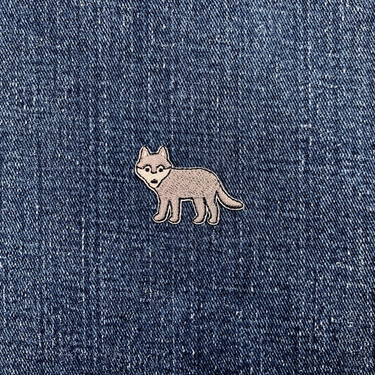 a mini wolf patch on a denim background