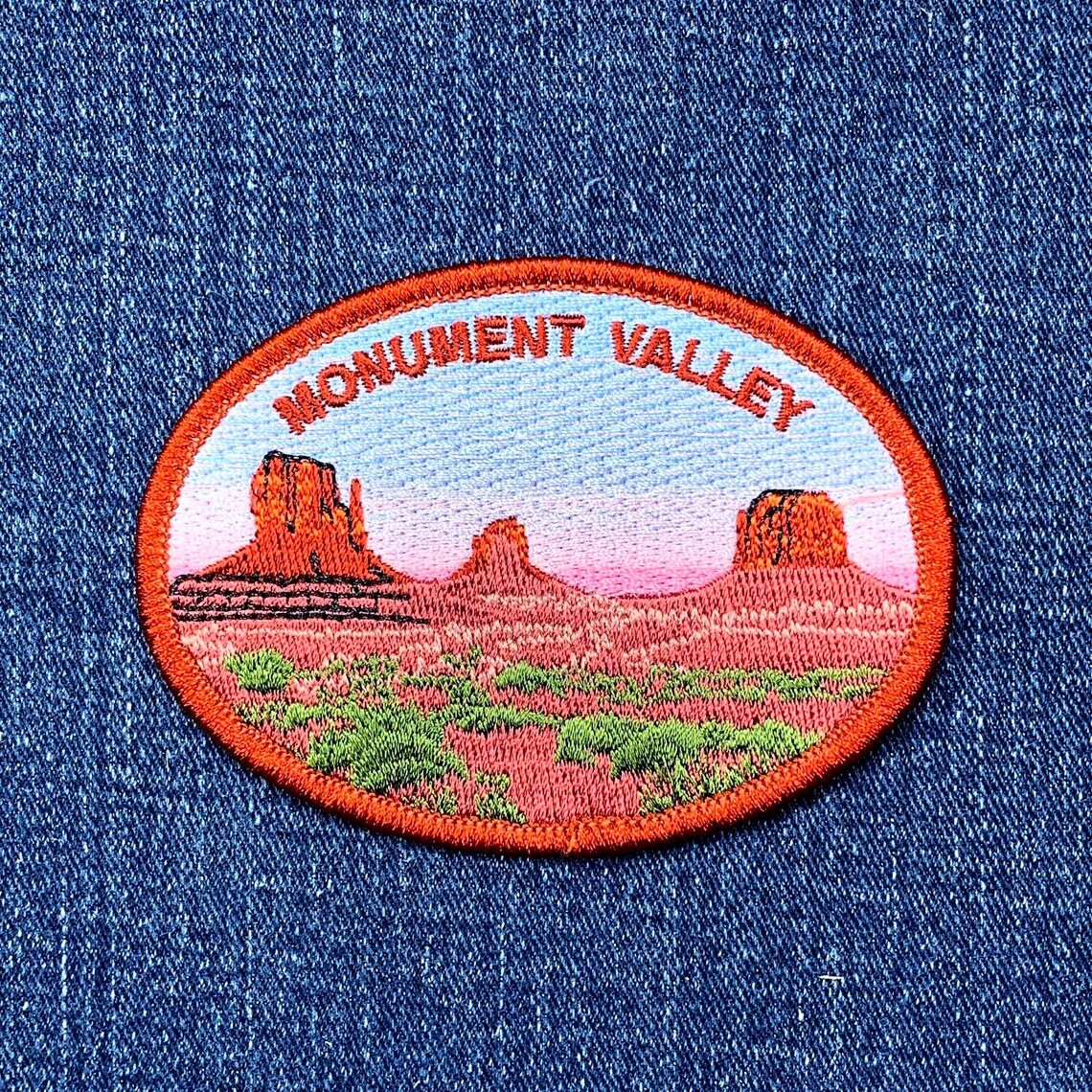 Embroidered patch of Monument Valley on a denim background