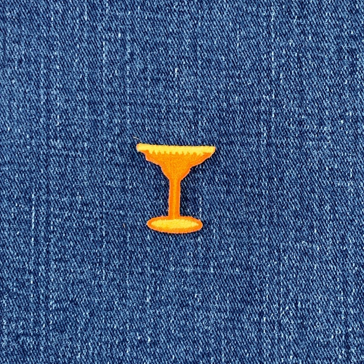 Orange cocktail glass patch on blue denim fabric