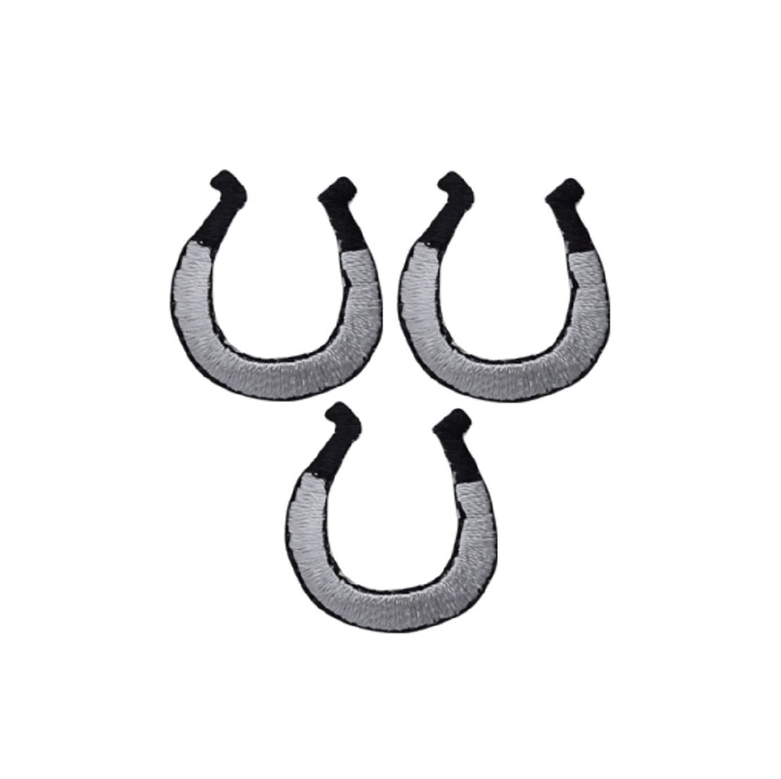 three silver and black horseshoe patches on a denim background