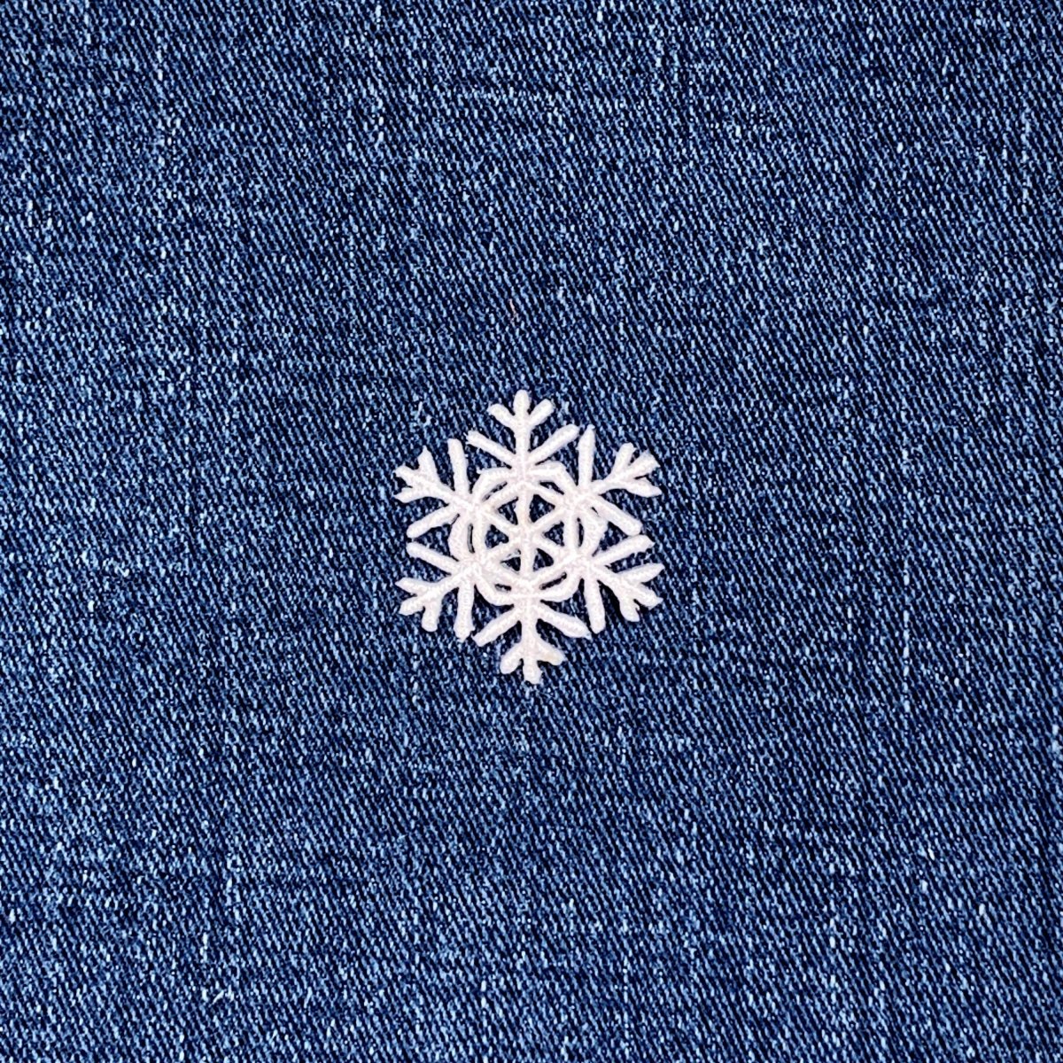 White snowflake patch on a blue denim background