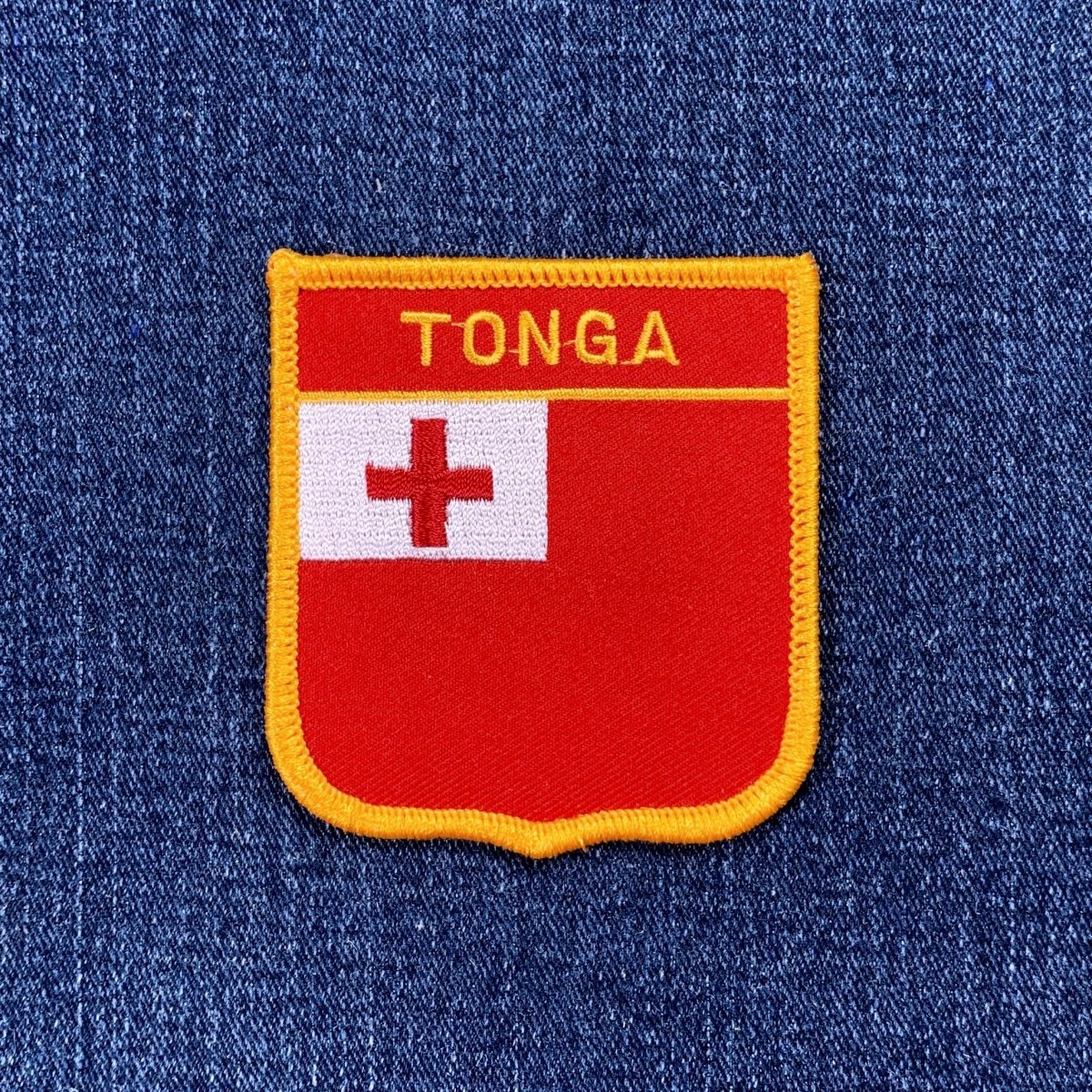Embroidered patch of Tonga's flag on a blue denim background