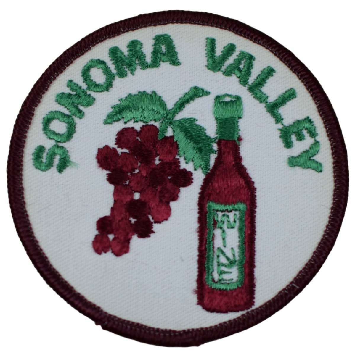 A circular embroidered patch featuring a cluster of dark red grapes and a bottle of red wine against a white background. The words 'SONOMA VALLEY' are stitched in green text around the top curve.