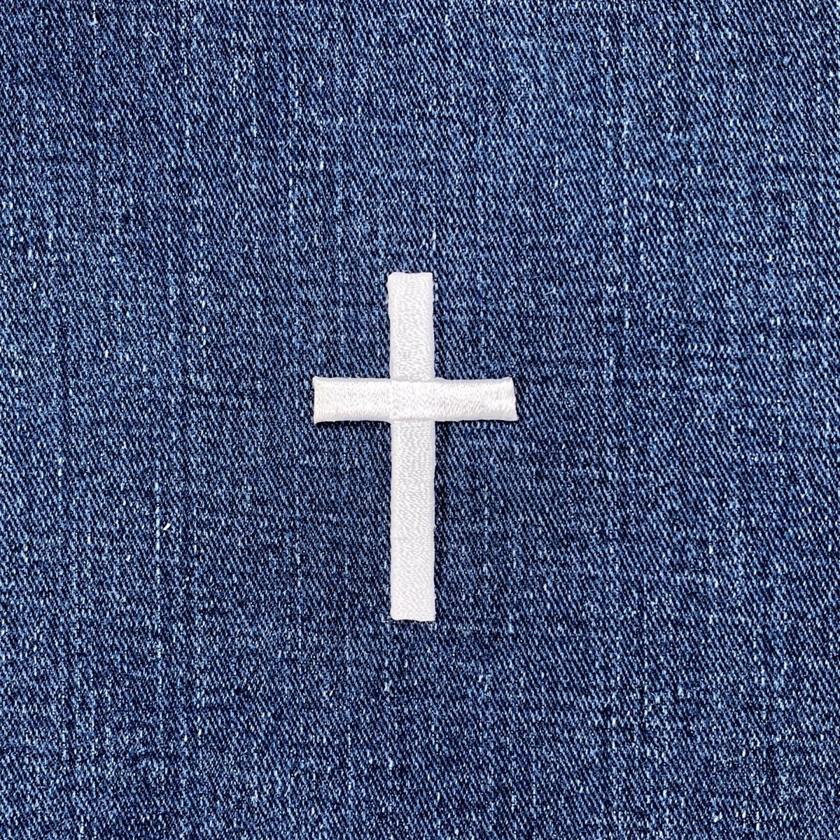White cross patch on blue denim fabric