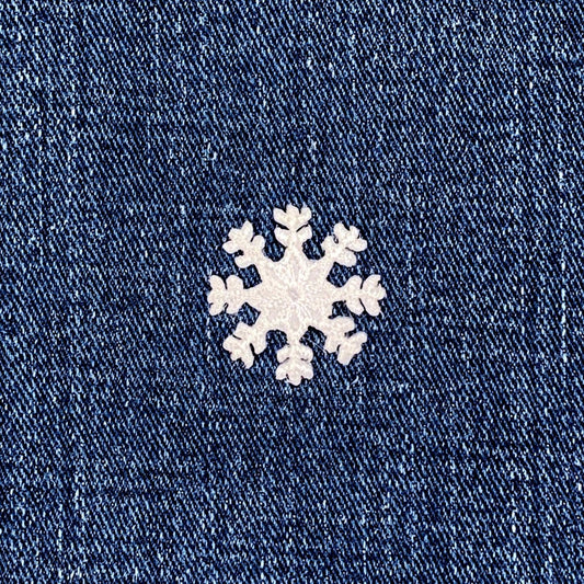White snowflake patch on a blue denim background